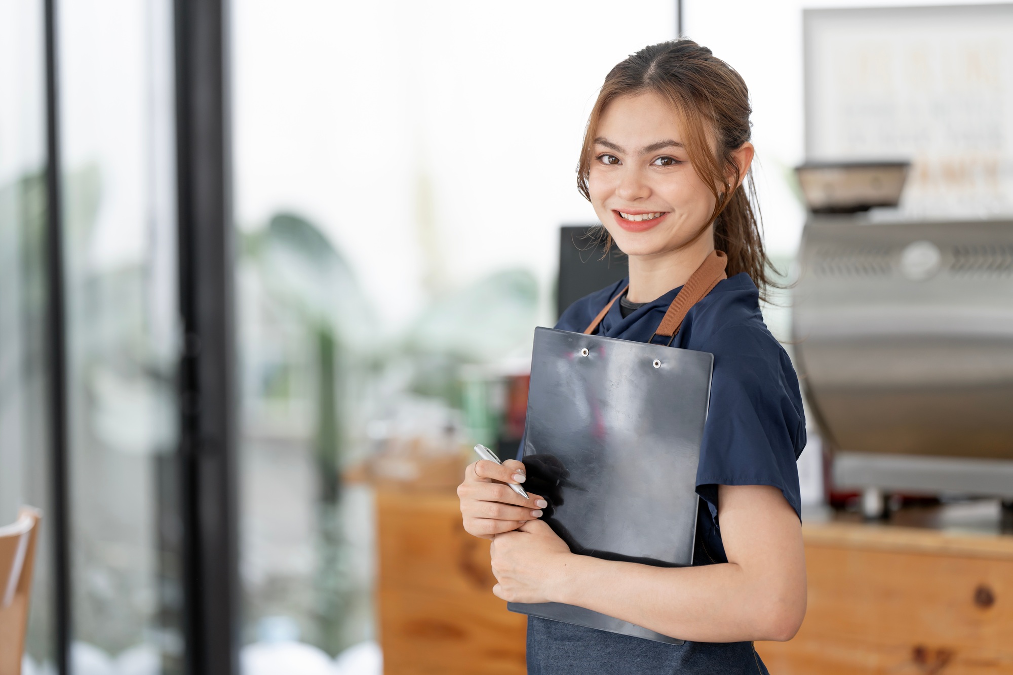 Smiling waitress or cafe business owner entrepreneur looking at camera